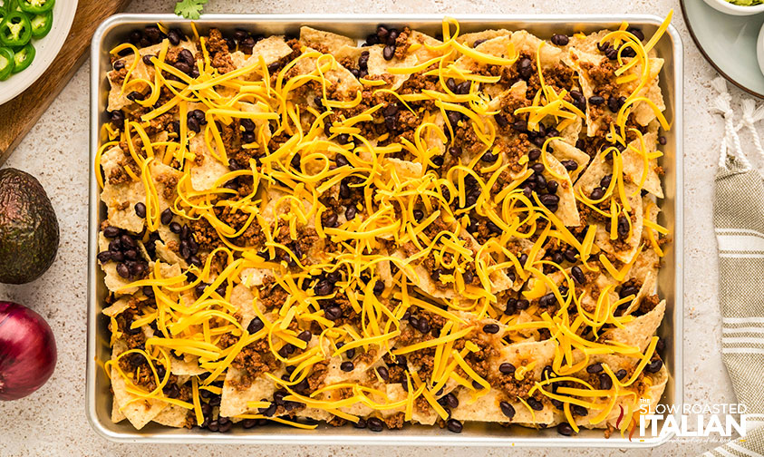 baked nachos sprinkled with shredded cheese