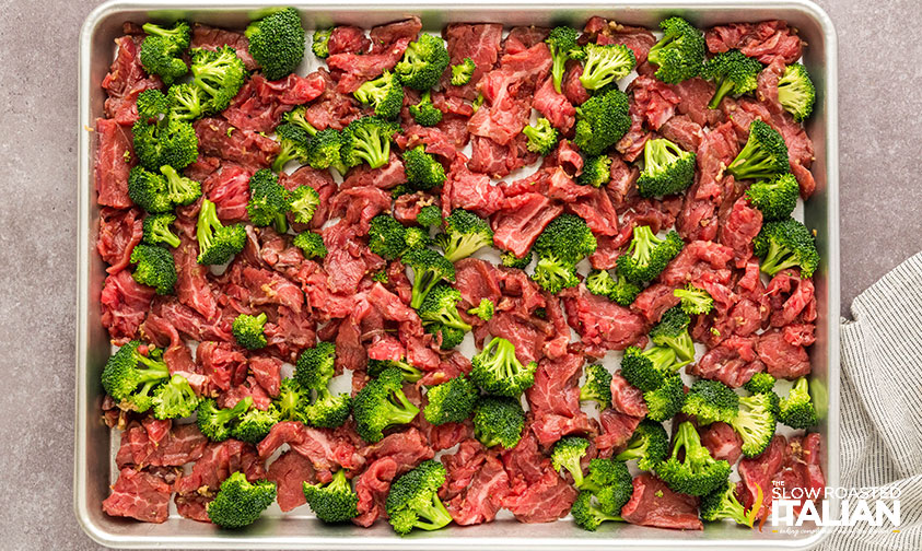 arrange sliced beef and broccoli on a sheet pan