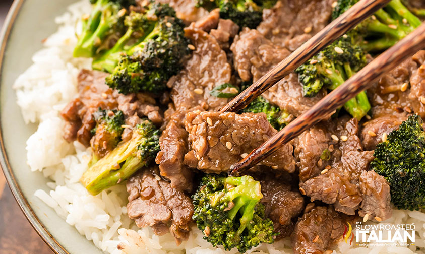 eating sheet pan broccoli and beef with chop sticks