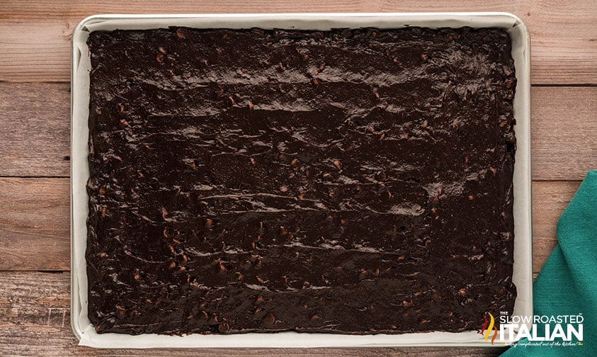spreading brownie batter into sheet pan