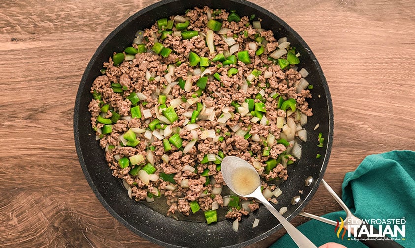 browned ground beef and veggies in a skillet