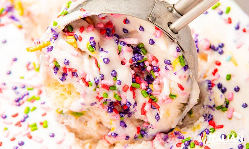 close up: scooping birthday cake flavored ice cream with sprinkles