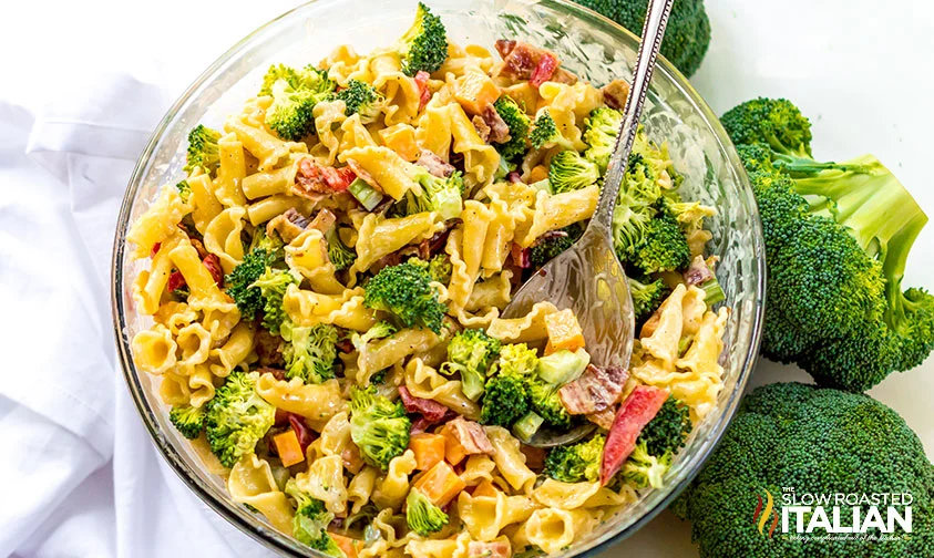 large bowl of broccoli noodle salad with serving spoon