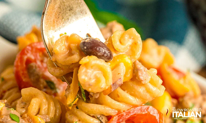 closeup: digging a fork into cowboy pasta salad
