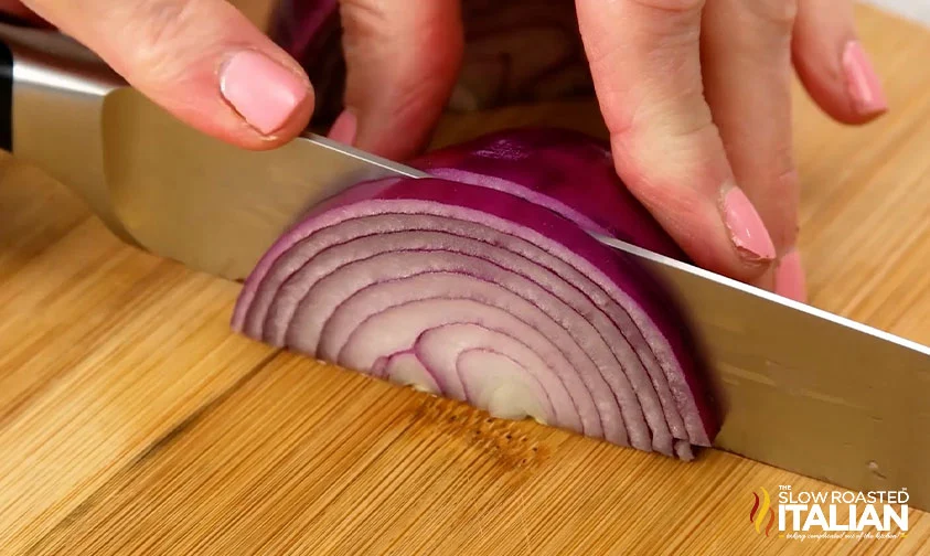 slicing half a red onion
