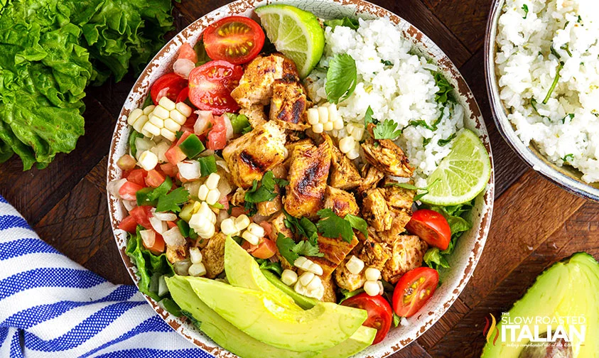 overhead: rice bowl with chipotle chicken, corn salsa, tomatoes, and avocado