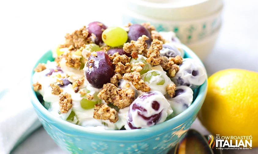creamy grape salad with granola in a small blue bowl
