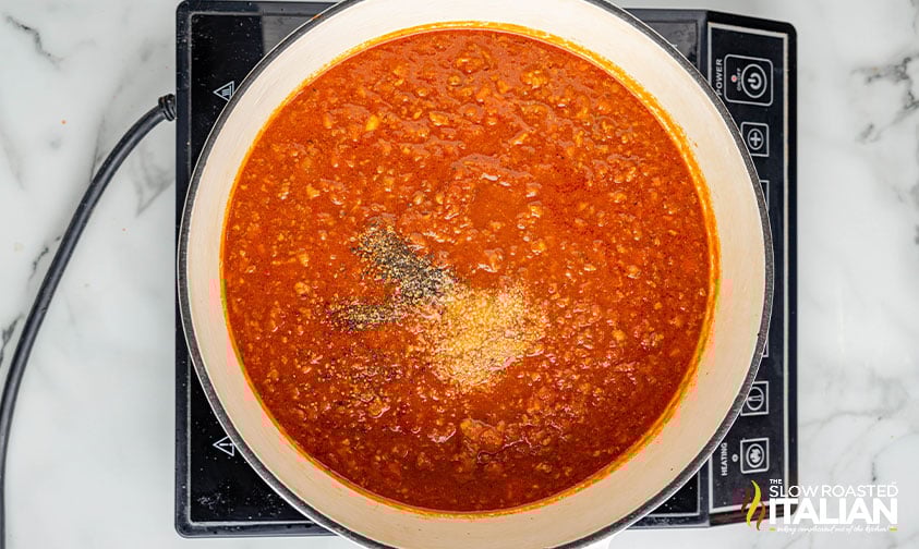 adding spices to bolognese sauce