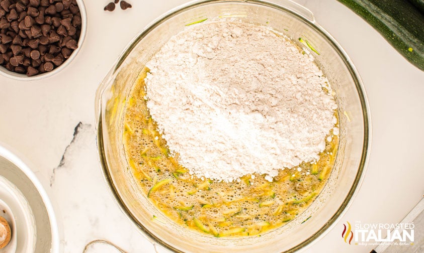 adding dry ingredients to chocolate chip zucchini bread recipe