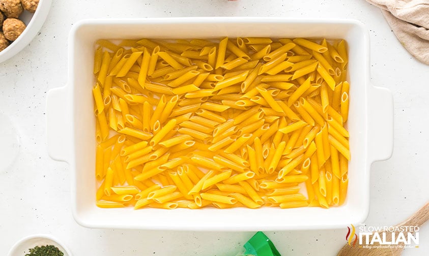 uncooked pasta in a 9x13 casserole dish