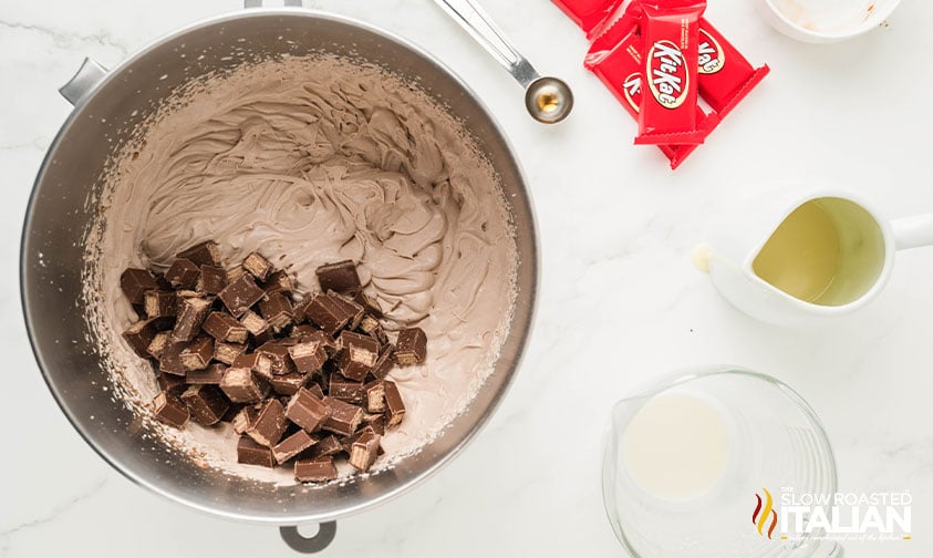 adding chopped kit kat bars to ice cream mixture