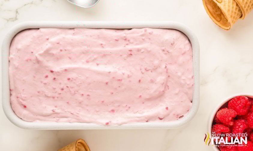 no churn raspberry ice cream mixture in a loaf pan