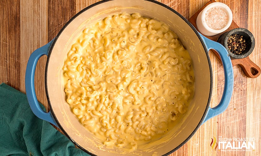 cooked pasta added to cheese sauce
