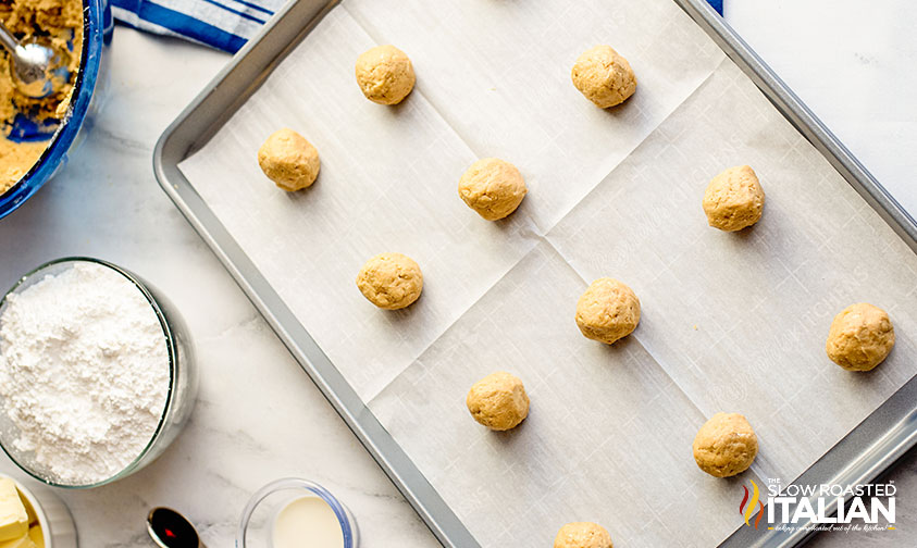 peanut butter sandwich cookie dough rolled into balls on a a baking sheet