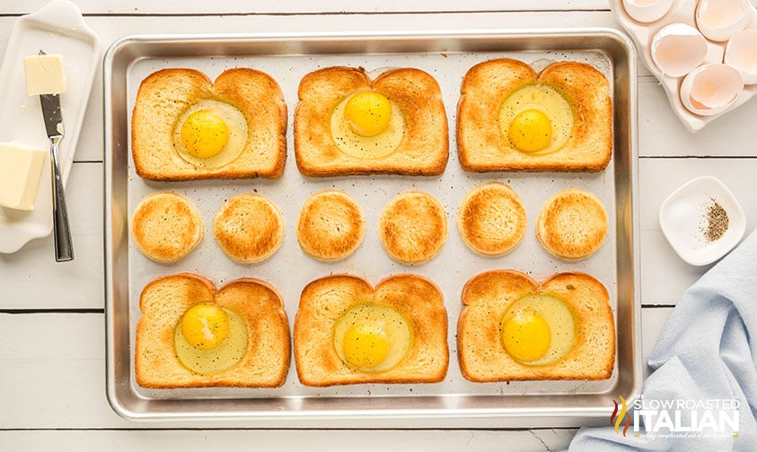 eggs cracked in the center of toasted bread