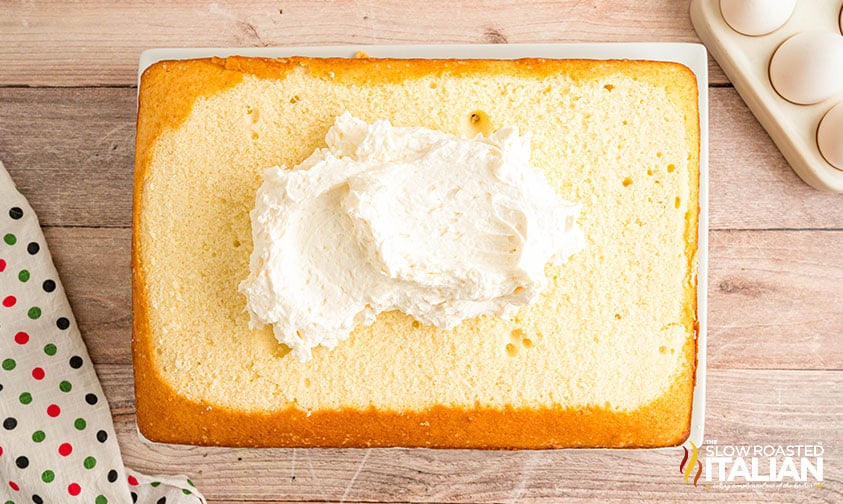 adding buttercream to layered costco sheet cake