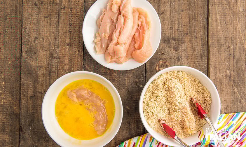 dredging chicken tenders in egg and breadcrumbs