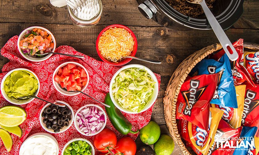bowls of toppings and basket of chip bags for walking taco bar