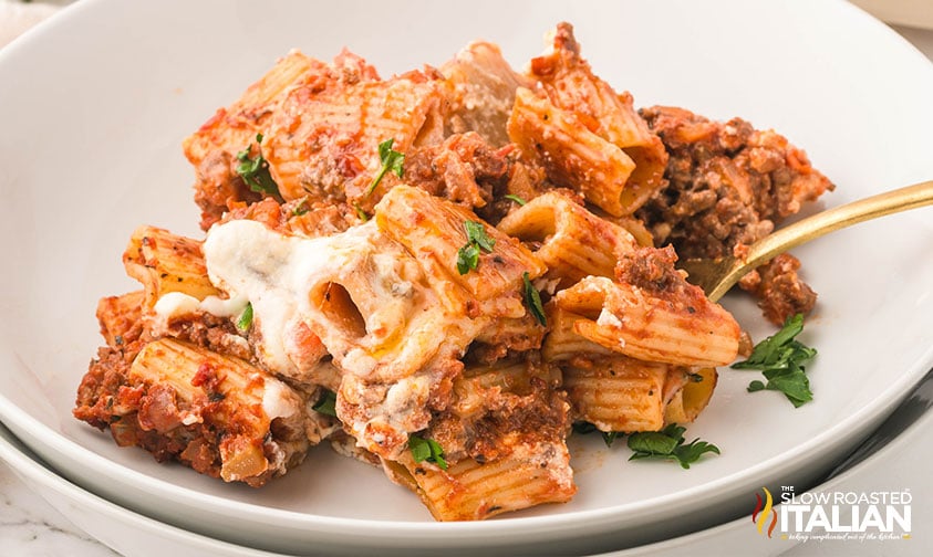 baked pasta bolognese on a white plate