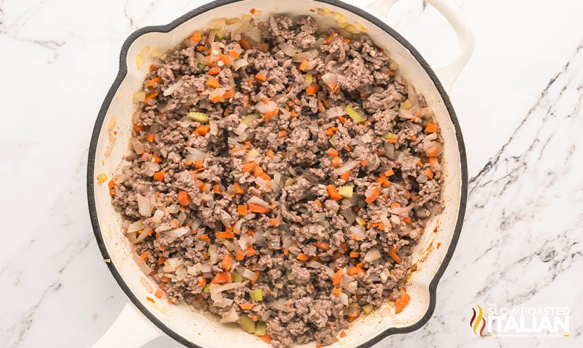 browned meat added to sauteed vegies n a large pot