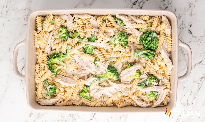 ingredients for chicken alfredo casserole with broccoli in a baking dish