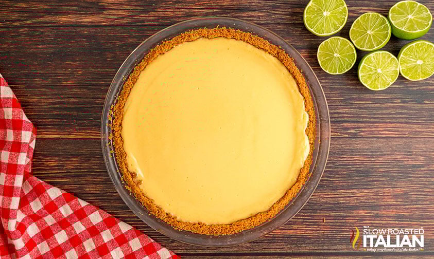 filling graham cracker pie crust with key lime pie filling