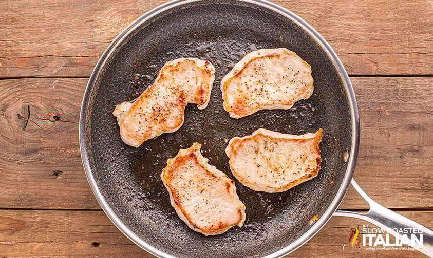 seared pork chops in a skillet