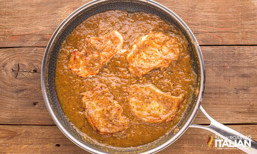 pork chops in gravy in a skillet