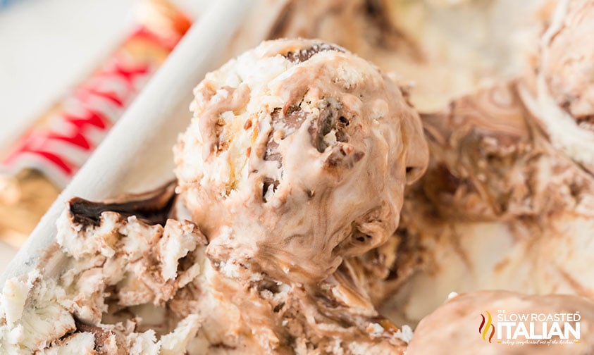 scoop of twix ice cream slightly melting
