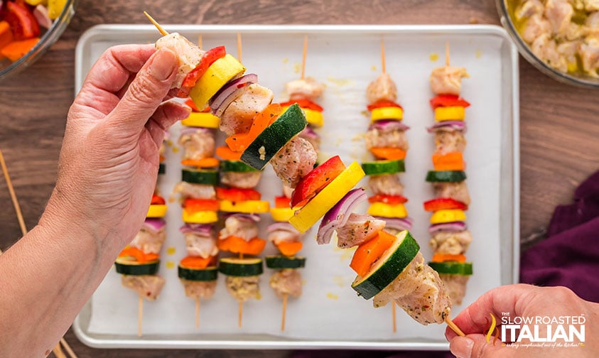 assembling chicken and vegetable skewers