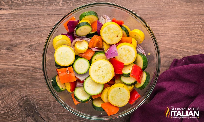 marinating chopped veggies in a large bowl