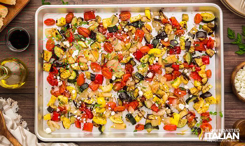 sprinkled ratatouille with goat cheese, balsamic glaze and fresh herbs