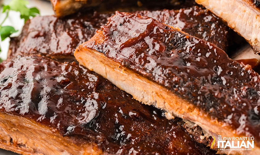 sheet pan ribs brushed with barbecue sauce on a plate