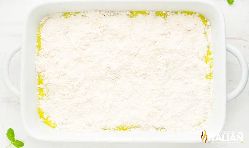 yellow cake mix sprinkled over lemon filling in baking dish