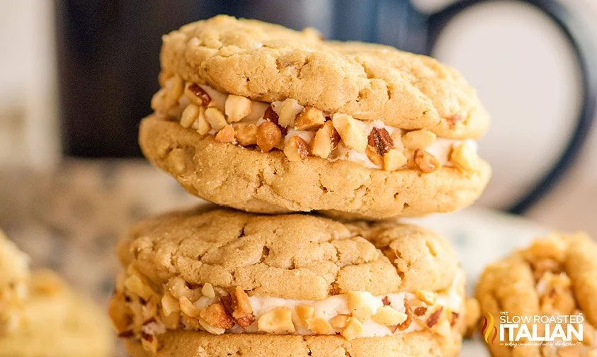 peanut butter cookie sandwiches with icing, rolled in chopped peanuts