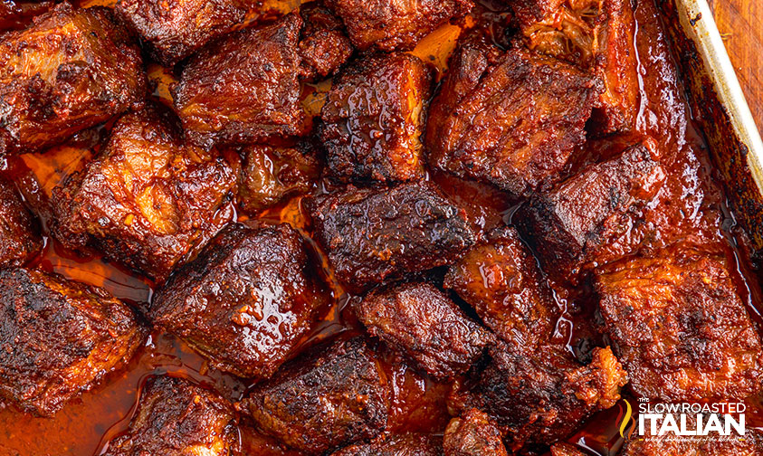 close up: crispy pieces of chuck roast coated in barbecue sauce