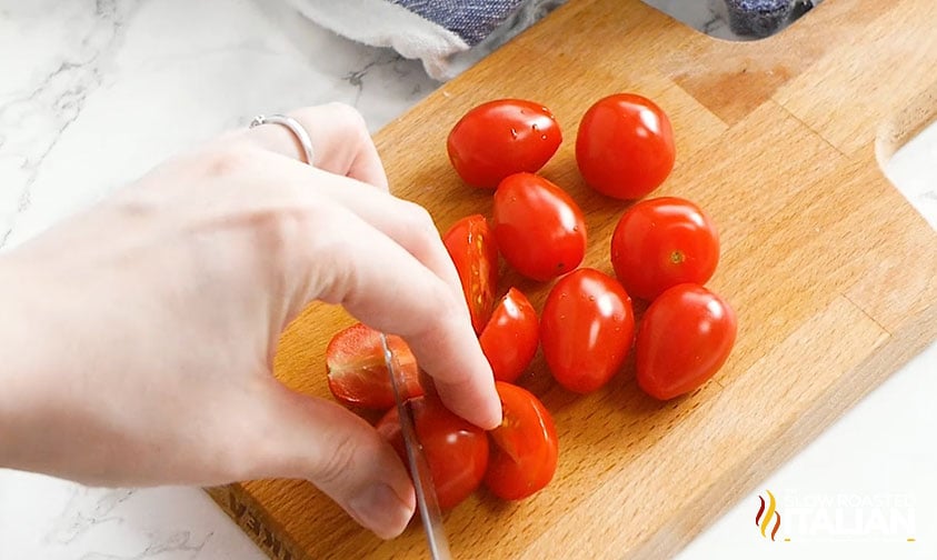slicing cherry tomatoes in half