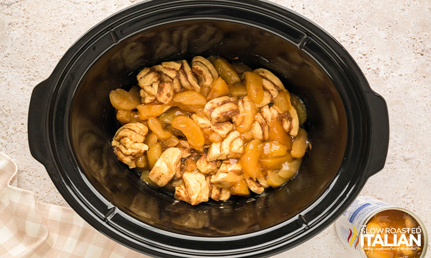 cinnamon roll quarters and apple pie filling added to crockpot
