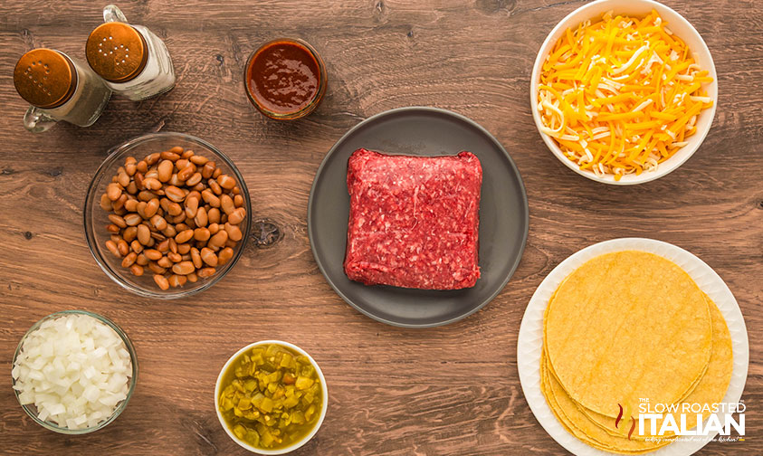 ingredients for beef and bean enchiladas recipe in small bowls