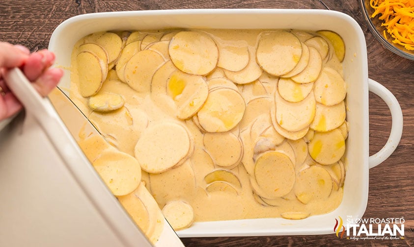 potatoes au gratin mixture poured into a 9x13 baking dish