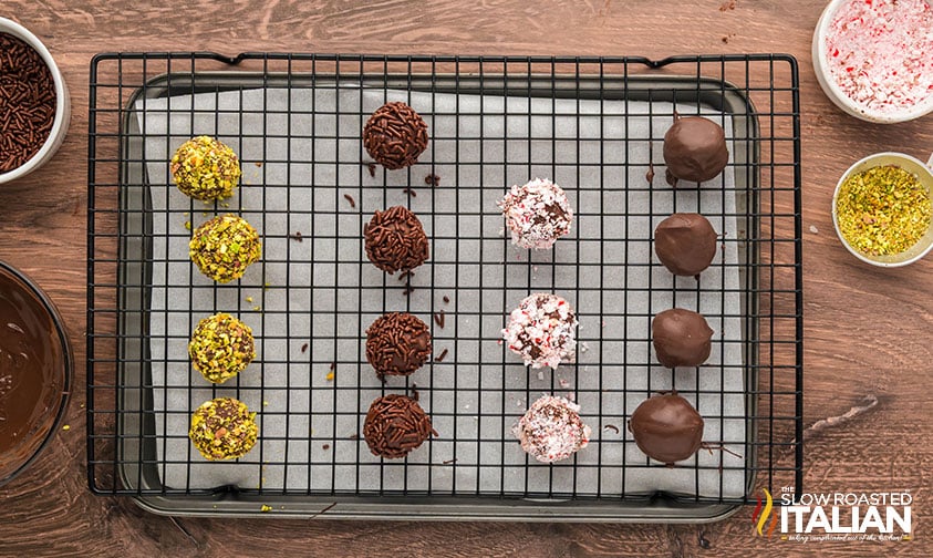 chocolate truffles dipped in toppings on a wire rack