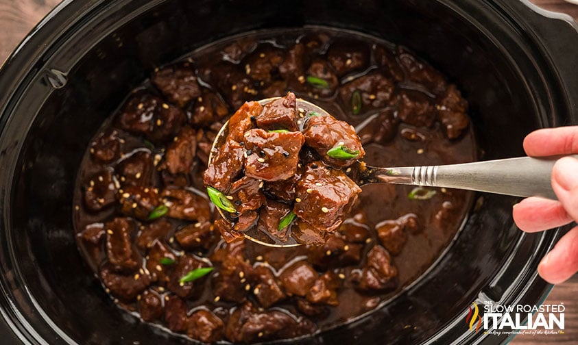 crockpot korean bbq beef in a ladle