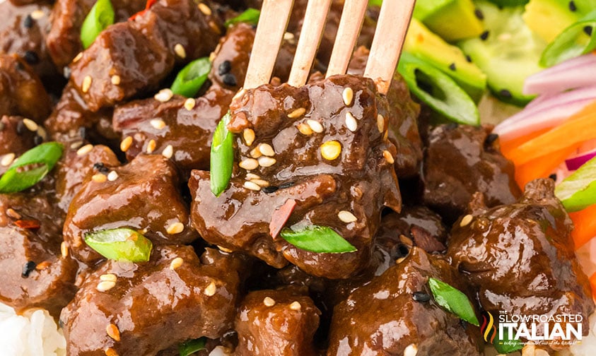 closeup of crockpot korean bbq beef on a fork