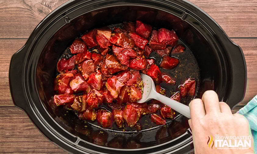adding korean bbq sauce to cubed beef in crockpot