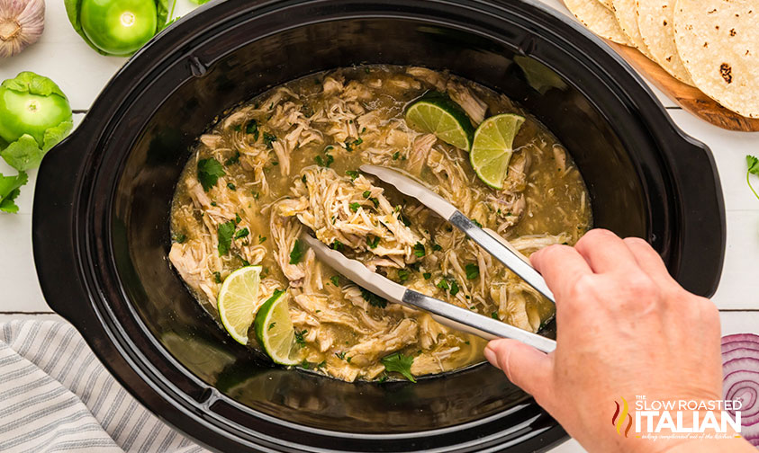 lime juice and chopped cilantro added to shredded chicken in crockpot