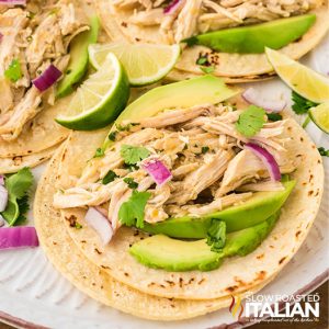 closeup of crockpot salsa verde chicken on tortillas