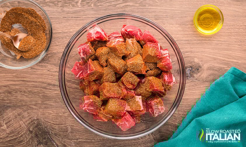 chunks of steak with seasoning in a bowl for chili