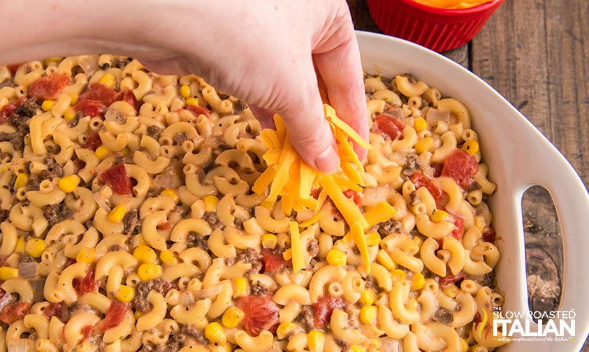 sprinkling cheese on hamburger casserole