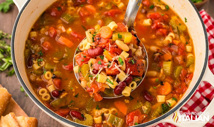 hearty pasta e fagioli soup in a ladle