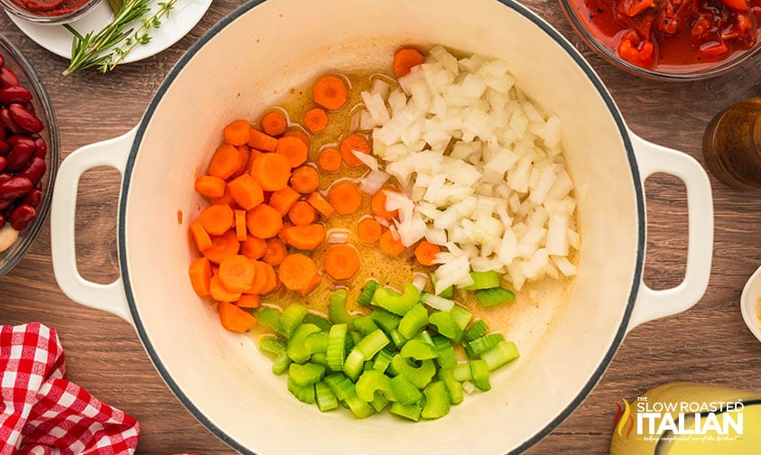 sautéing chopped carrots, onion, and celery in a dutch oven